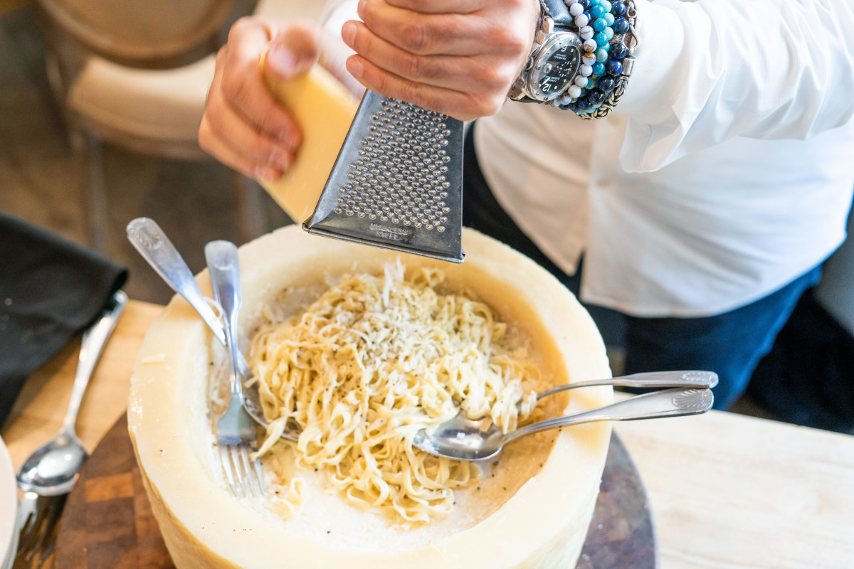 adding cheese to the pasta